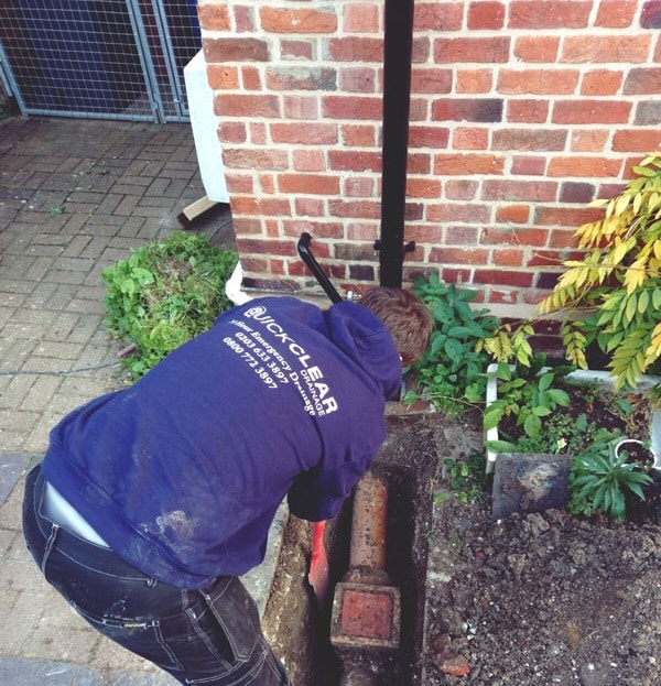 Engineer repairing blocked drains in Islington, London